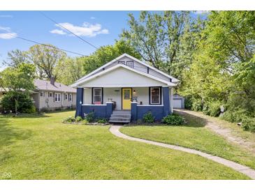 Charming bungalow-style home featuring a well-manicured lawn and inviting yellow front door at 5817 Beechwood Ave, Indianapolis, IN 46219