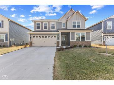 Charming two-story home featuring a two-car garage and welcoming front lawn, in a modern neighborhood at 8673 Laurelton Pl, Brownsburg, IN 46112