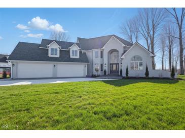 Stunning two-story home featuring a three-car garage and a well-manicured lawn at 12536 Lowery Way, Fishers, IN 46037