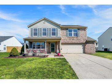 Charming two-story home with brick and siding, attached two-car garage, and covered front porch at 1330 Redwood Dr, Greenfield, IN 46140