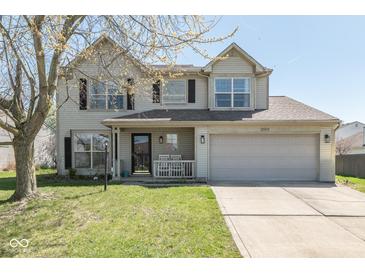 Charming two-story home with a well-manicured lawn, inviting porch, and an attached two-car garage at 13971 Bruddy Dr, Fishers, IN 46038
