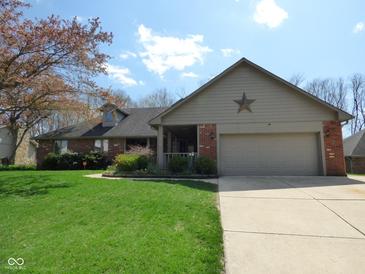 Charming brick home with a well-manicured lawn, covered porch, and a two-car garage at 1737 Friendship Dr, Indianapolis, IN 46217