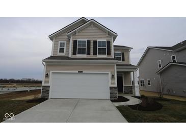Two-story home with a two-car garage, neutral siding, black shutters and modern fixtures at 2252 Marjorie Way, Shelbyville, IN 46176
