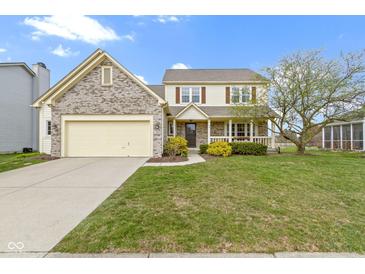 Charming two-story home featuring a welcoming front porch and manicured lawn in a suburban neighborhood at 300 Wyndotte Dr, Carmel, IN 46032