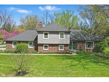 Charming brick and siding home featuring a well-maintained lawn and inviting curb appeal at 4337 Lincoln Rd, Indianapolis, IN 46228
