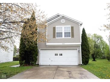 Charming home featuring a two-car garage and a well-maintained front yard with mature landscaping at 4545 Connaught East Dr, Plainfield, IN 46168