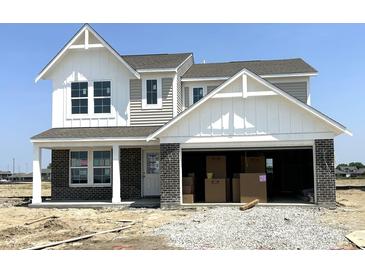 Charming two-story home with a brick-and-siding exterior and an attached two-car garage at 792 Oakleaf Dr, Greenfield, IN 46140
