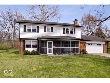 Charming two-story home featuring a well-manicured lawn and an inviting screened-in porch area at 8180 E County Road 400 N, Brownsburg, IN 46112
