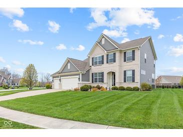 Two-story home featuring a three-car garage and a lush front lawn with manicured landscaping and a concrete driveway at 1334 Winfield Way, Greenwood, IN 46143