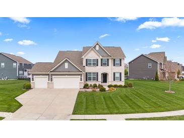 Beautiful two-story home with a manicured lawn, a three-car garage, and a classic brick and siding facade at 1334 Winfield Way, Greenwood, IN 46143