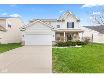 Charming two-story home featuring a two-car garage, stone accents, and a well-manicured lawn at 15144 Dry Creek Rd, Noblesville, IN 46060