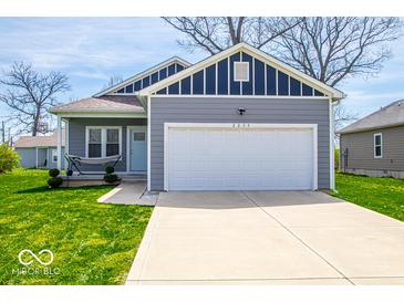 Charming single-story home featuring a two-car garage, landscaped front yard, and inviting hammock at 2239 E Werges Ave, Indianapolis, IN 46237