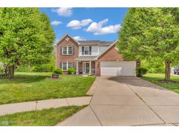 Traditional two-story home featuring a brick facade, attached two car garage, and well-maintained landscaping at 2303 Cole Wood Ct, Indianapolis, IN 46239