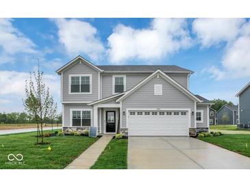 Charming two-story home featuring stone accents, a well-manicured lawn and a two car garage at 2764 Glade Ave, Plainfield, IN 46168