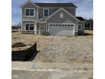 Newly built two story home featuring a two car garage and stone accents near the entryway at 2764 Glade Ave, Plainfield, IN 46168