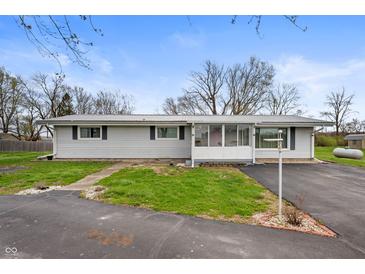 Charming single-story home with a well-maintained yard and enclosed front porch at 3335 W 400 N, Anderson, IN 46011