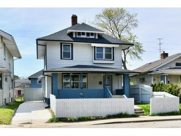 Charming two-story home featuring a covered porch and a well-maintained front yard at 3516 N Capitol Ave, Indianapolis, IN 46208