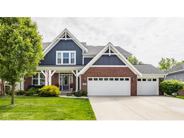 Charming two-story home featuring a brick and blue facade, complemented by a well-manicured lawn at 3640 Snowdon Dr, Westfield, IN 46074