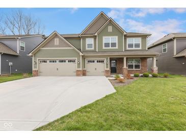 Charming two-story home with a well-manicured lawn, three-car garage, and inviting curb appeal at 3737 Planck St, Danville, IN 46122