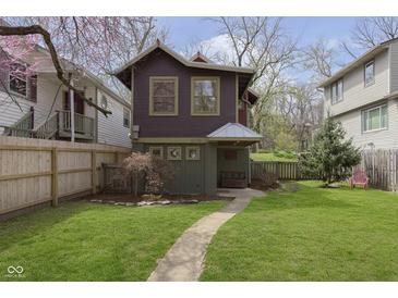 Charming two-story home with a well-manicured lawn and a walkway leading to the front entrance at 5110 Riverview Dr, Indianapolis, IN 46208