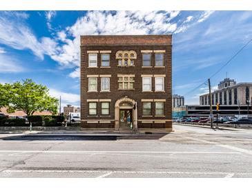 Striking brick building featuring an arched doorway and decorative stone accents, offering a unique architectural appeal at 801 N Pennsylvania St # Apt D, Indianapolis, IN 46204