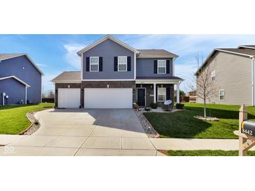 Charming two-story home featuring a well-manicured lawn, neutral siding, and a two-car garage, embodying modern suburban living at 8442 Averly Park Dr, Indianapolis, IN 46237
