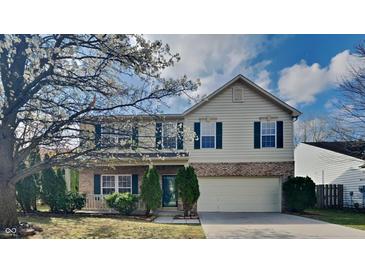 Traditional two-story home featuring green shutters, brick accents, and a well-maintained lawn at 10689 Brooks St, Indianapolis, IN 46234