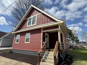 Charming red two-story home with a cozy front porch and newly landscaped garden at 128 W Walnut St, Lebanon, IN 46052