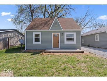 Charming bungalow featuring a light green exterior, a brown roof, and a small, quaint front yard at 1409 S Kiel Ave, Indianapolis, IN 46241