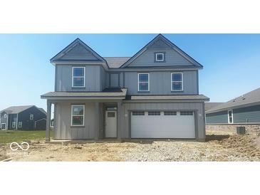 Charming two-story home with a gray exterior, a white garage door, and a welcoming front porch at 1656 Winn Ct, Fortville, IN 46040