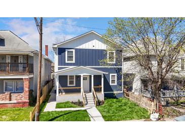 Charming two-story home featuring a welcoming front porch and freshly landscaped yard at 2326 Guilford Ave, Indianapolis, IN 46205
