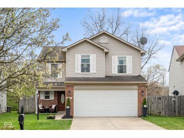 Charming two-story home featuring a two-car garage, brick accents, and mature trees in a well-kept front yard at 4417 Barharbor Ct, Indianapolis, IN 46268