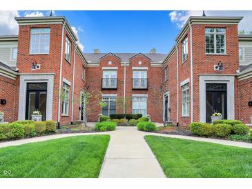 Brick townhome complex with manicured landscaping and a well-maintained walkway at 6430 Meridian Pkwy # Apt A, Indianapolis, IN 46220