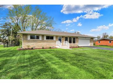 Charming single-story home with stone facade, attached garage, and beautifully maintained lawn at 6826 Hague Rd, Indianapolis, IN 46256