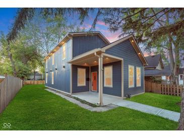 Charming two-story home with a manicured lawn and inviting front porch at 838 N Tacoma Ave, Indianapolis, IN 46201