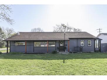 Charming single-story home with well-manicured lawn, gray siding, and ample natural light at 91 Crestview Dr, Greenwood, IN 46143