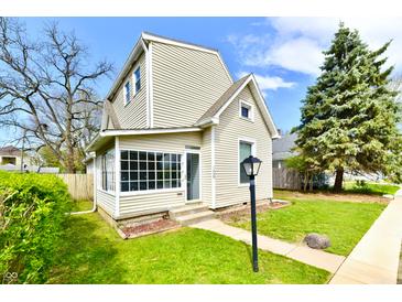 Charming two-story home with a well-maintained lawn and mature trees offering curb appeal at 106 S Wayburn St, Indianapolis, IN 46229