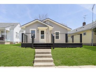 Charming bungalow featuring a welcoming porch, light gray siding and manicured front lawn at 109 S 10Th S Ave, Beech Grove, IN 46107