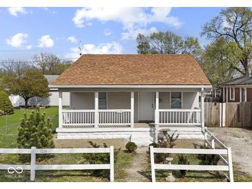 Charming single-story home with a cozy front porch and well-maintained lawn at 1739 N Alton Ave, Indianapolis, IN 46222