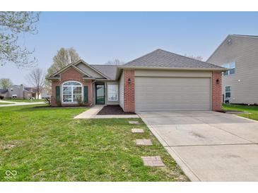 Charming single Gathering home with a two-car garage, red brick accents, and well-maintained landscaping at 2075 Sea Hero Ct, Indianapolis, IN 46234