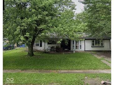 Traditional single-story home with a shaded front yard and a cozy front porch at 2508 N Routiers Ave, Indianapolis, IN 46219