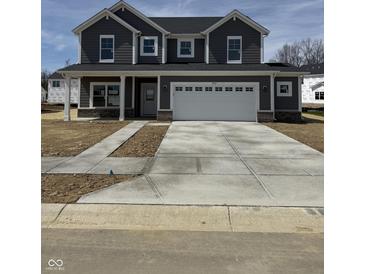 Charming two-story home with gray siding, white trim, large garage, and concrete driveway at 2712 Glade Ave, Plainfield, IN 46168
