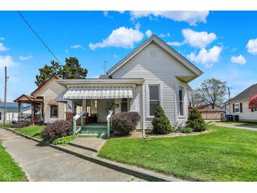 Charming two-story home with a manicured lawn and a covered front porch on a sunny day at 508 Miller Ave, Shelbyville, IN 46176