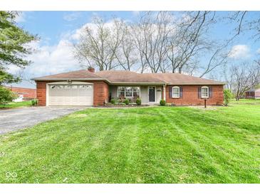 Charming single-story brick home featuring a well-maintained lawn and an attached two-car garage at 5927 Pine Hill Dr, Indianapolis, IN 46235