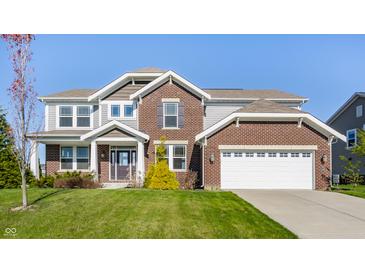 Two-story home features a brick and gray siding exterior, an attached two car garage, and a well manicured lawn at 6408 Askin Dr, Indianapolis, IN 46259