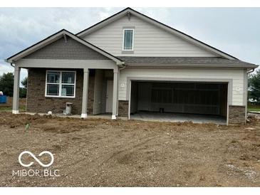 Charming single Gathering home with a two-car garage and covered front porch at 7533 Big Bend Blvd, Camby, IN 46113