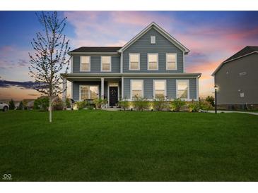 Charming two-story home with well-manicured lawn and inviting front porch at 12902 Girvan Way, Fishers, IN 46037