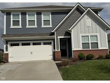 Charming two-story home with a well-manicured lawn, a two-car garage, and a welcoming front entrance at 1303 Eton Way, Avon, IN 46123