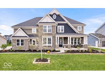 Beautiful two-story home featuring stone accents, a welcoming front porch, and professionally landscaped front yard at 1352 Trifecta Way, Westfield, IN 46074