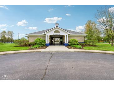 Community clubhouse featuring a welcoming entrance, white columns, and professionally landscaped gardens at 1361 Trescott Dr, Westfield, IN 46074